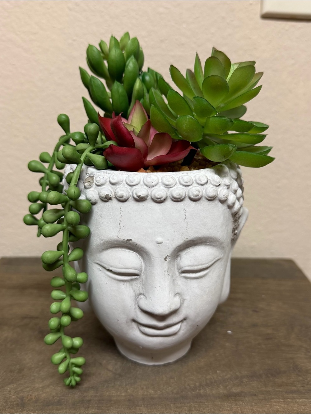 White Buddha Head Planter with Green and Red Succulents